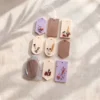 Noua tablete de ceara cu flori uscate, una dintre ele intr-un saculet de organza Noua tablete de ceara cu flori uscate, una dintre ele intr-un saculet de organza